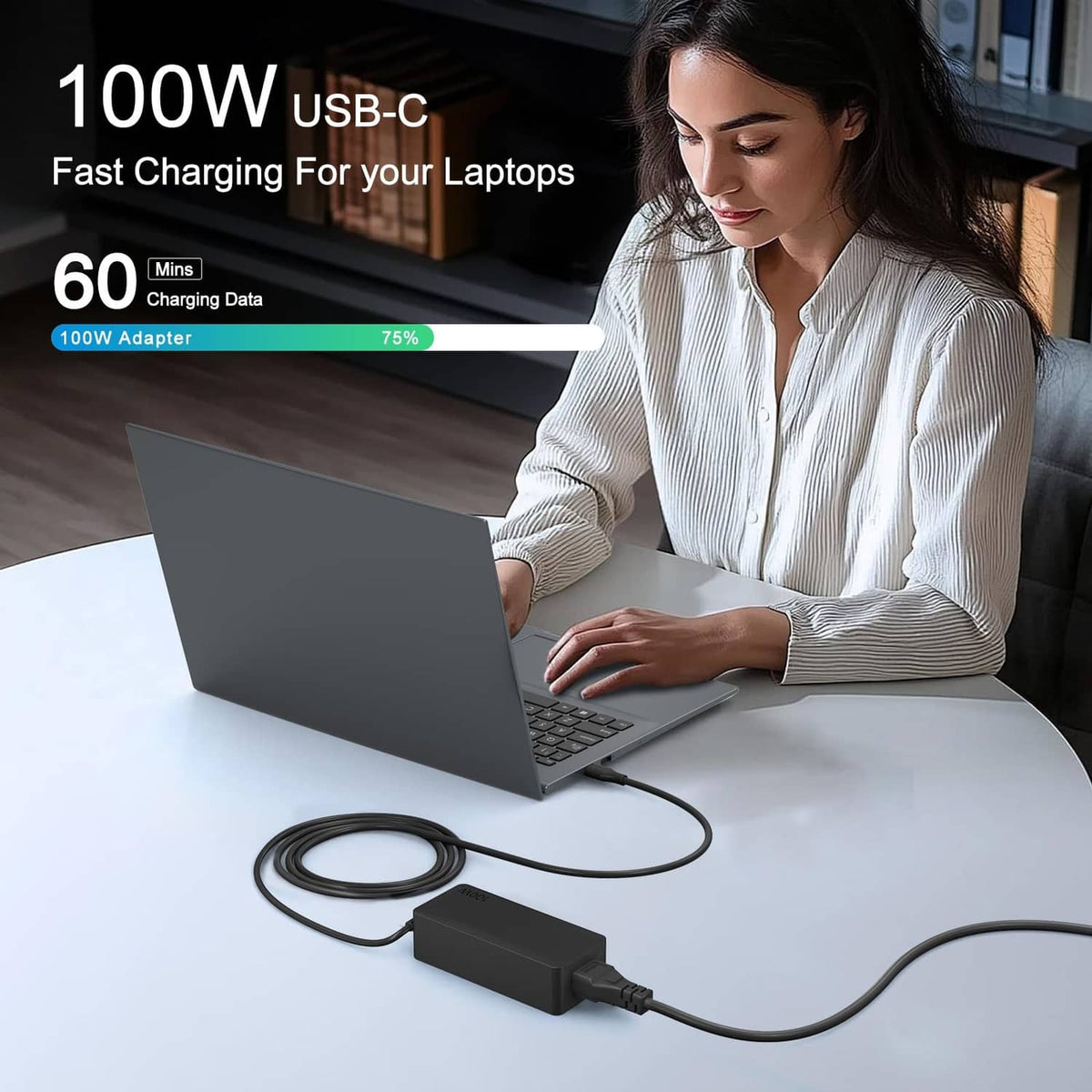 Black 100W USB-C charger with cable plugged in to laptop