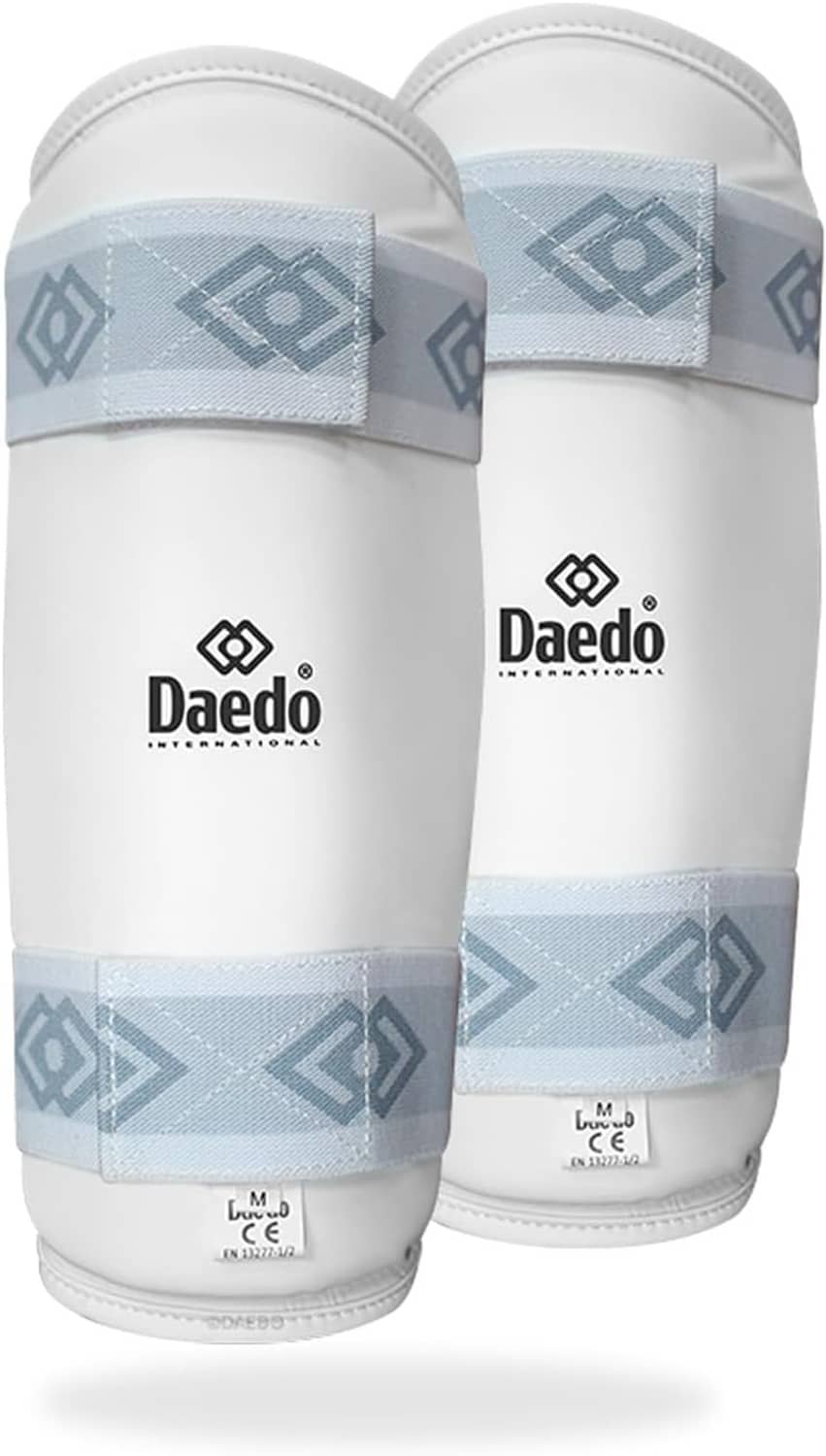 Taekwondo shin pads in white with light blue patterned accents and two elastic straps