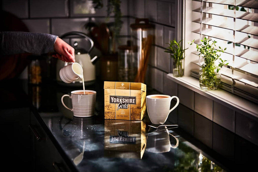 Yorkshire Gold tea bag box on countertop beside pour kettle and mugs