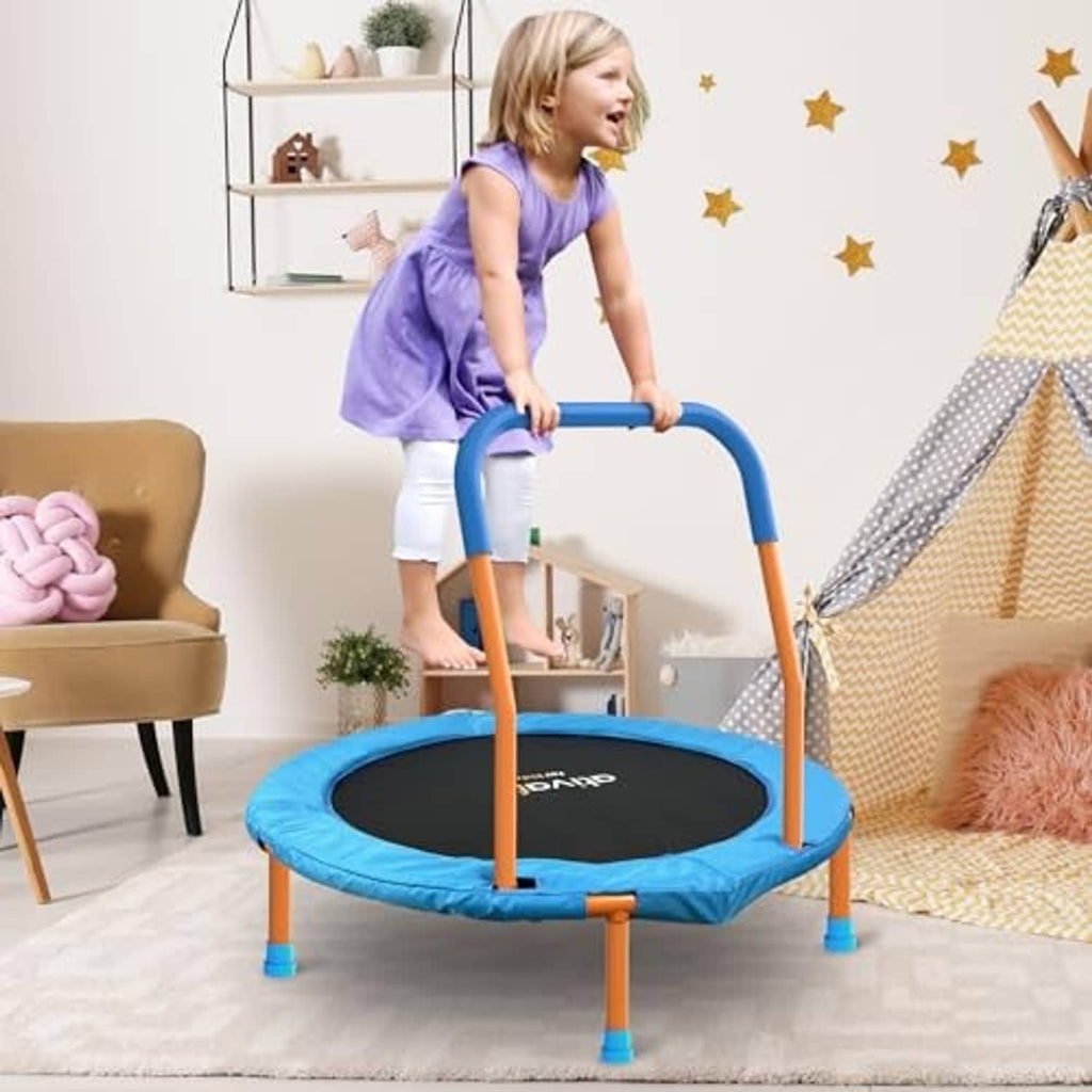 Toddler trampoline in living room with blue mat, orange legs, and blue foam handle; child jumping