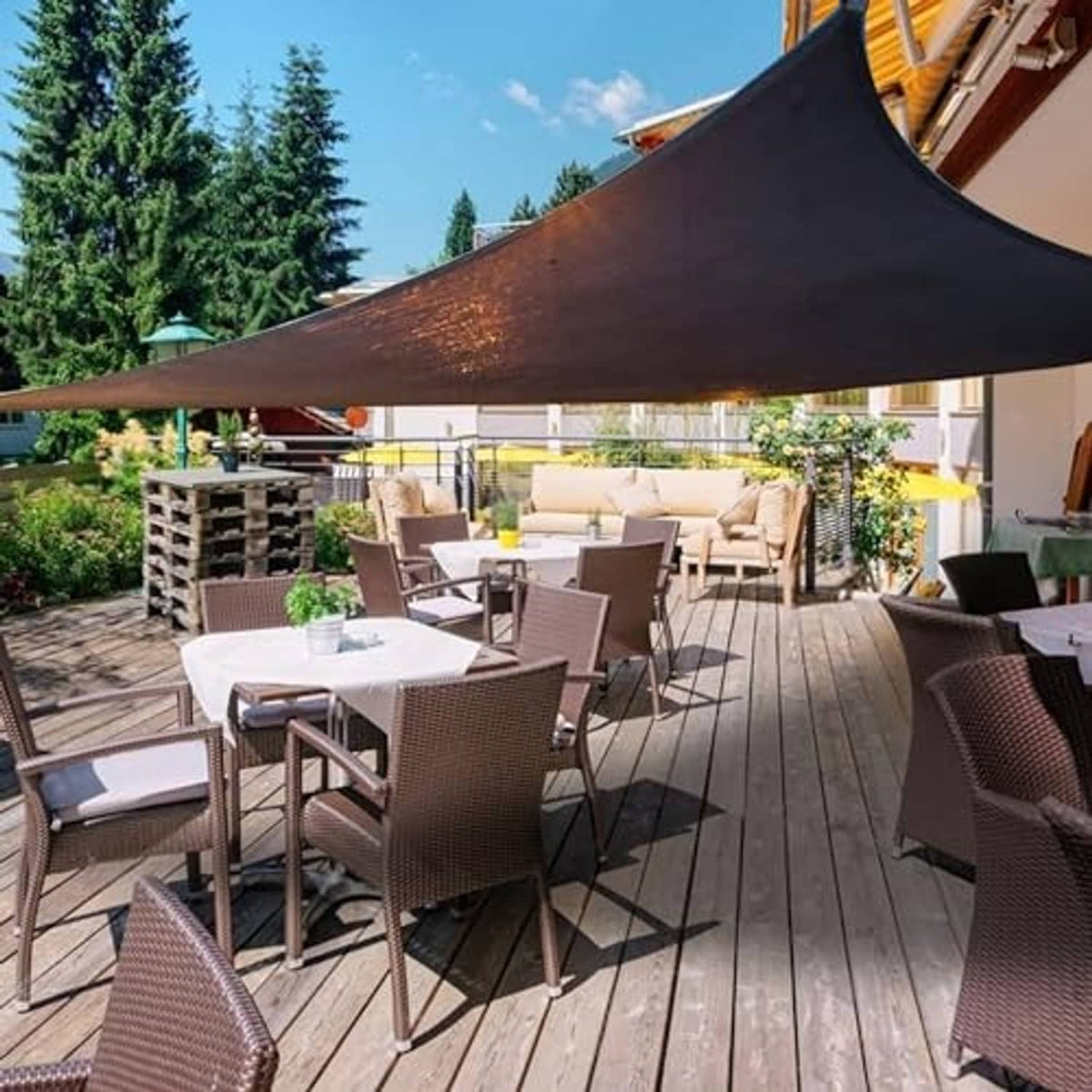 Black shade cloth canopy with grommet corners over outdoor patio seating