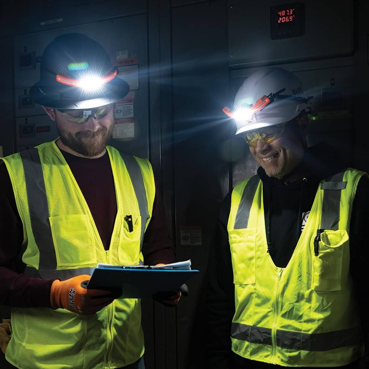 Two workers wearing rechargeable LED headlamps shining bright white beams