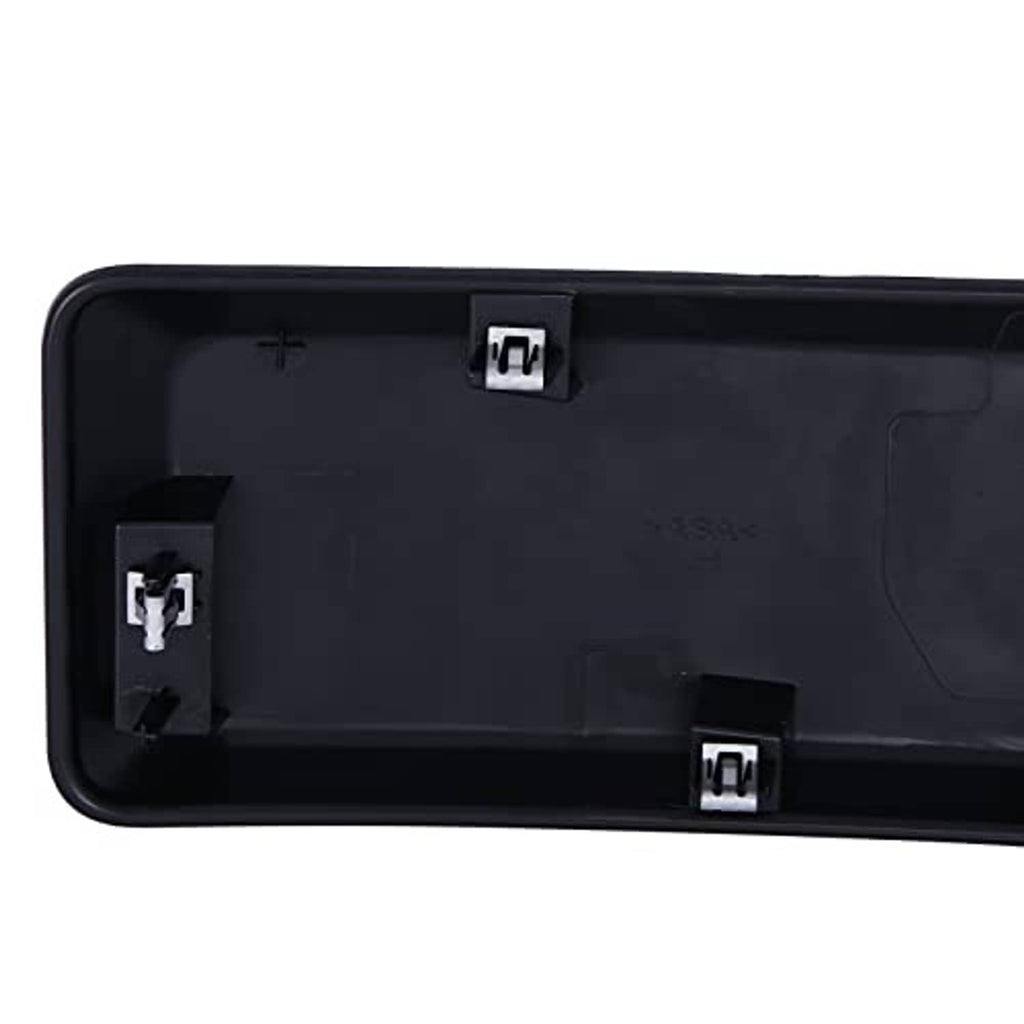 Back side of dark plastic grille cover insert with wiring/connector clips