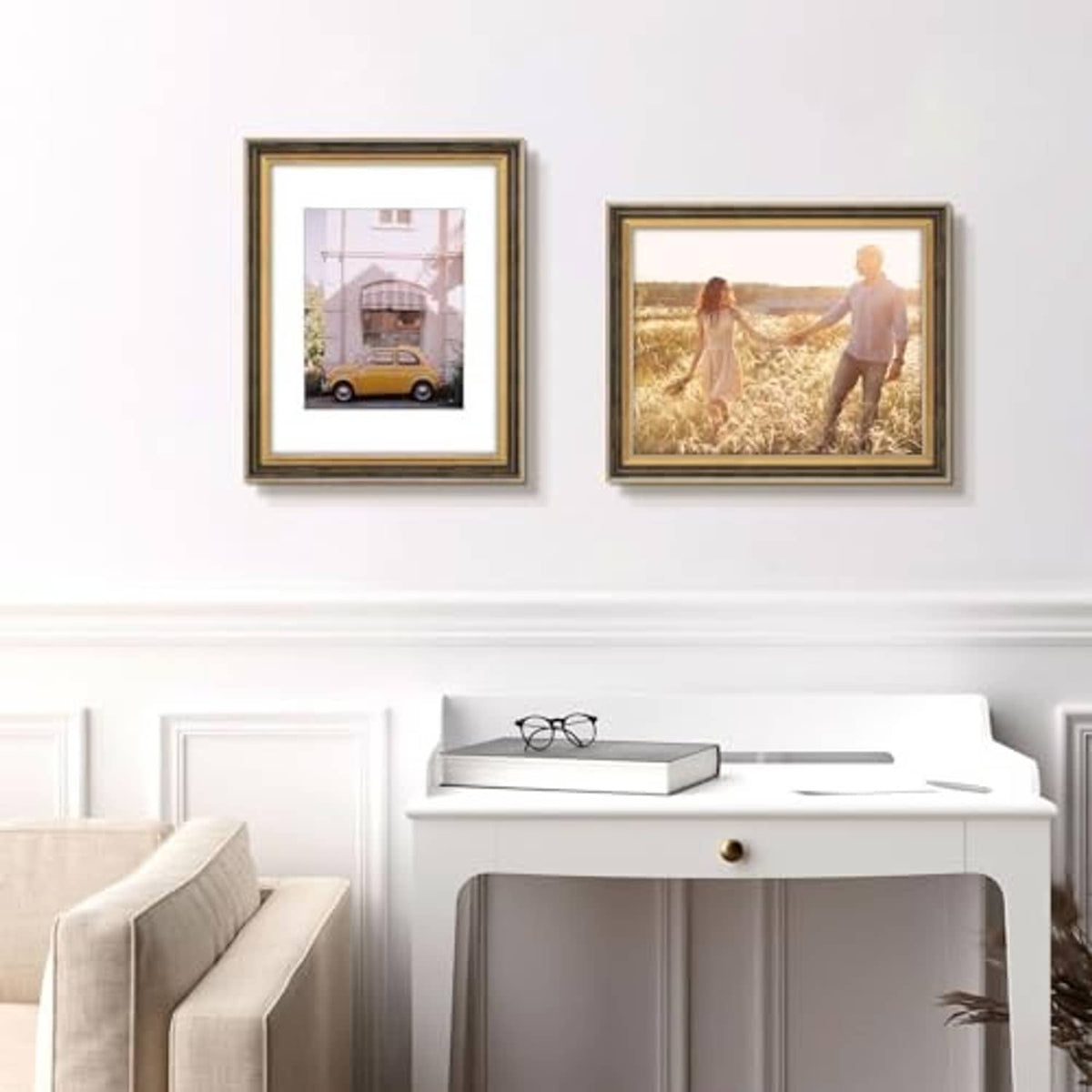 Two gold and dark-brown ornate picture frames hanging on a wall