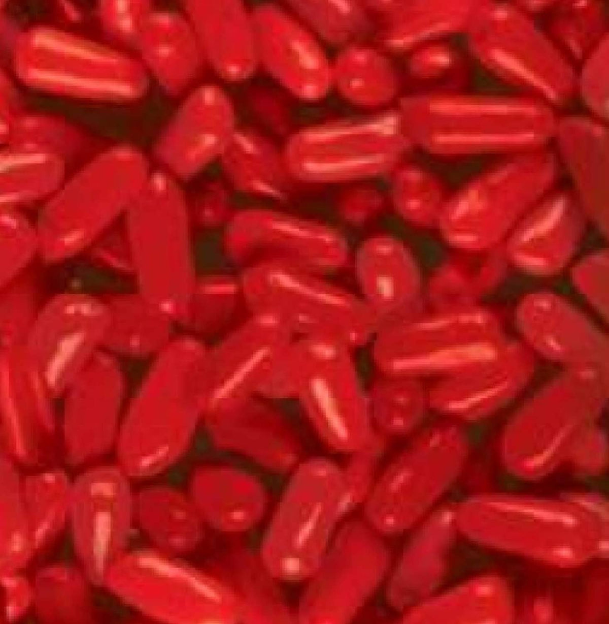 Hot Tamales cinnamon candies close-up, red elongated candy pieces