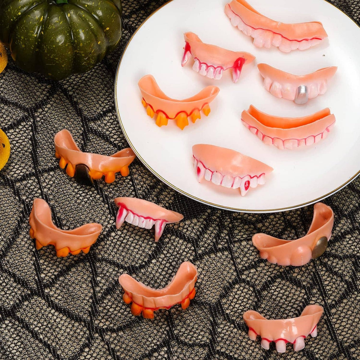 12-piece Halloween vampire teeth assortment, orange and pink gums with fangs on plate