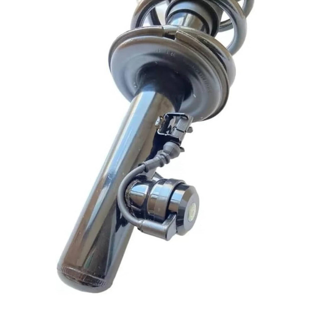 Strut assembly detail: chrome-like upper tube, rubber boot, and small sensor-style module.