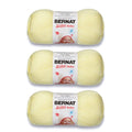 Three pale yellow baby yarn skeins with BERNAT Softee Baby labels
