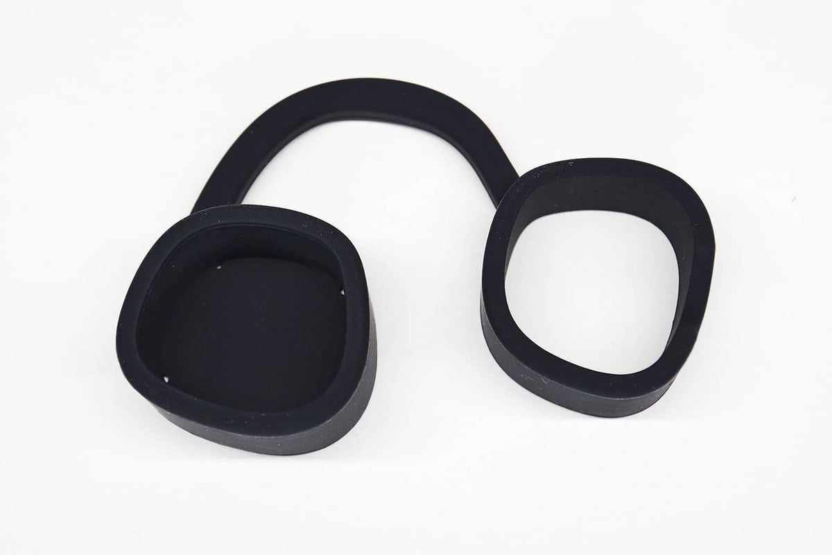 Two black silicone cap protector pieces with circular openings and raised rims