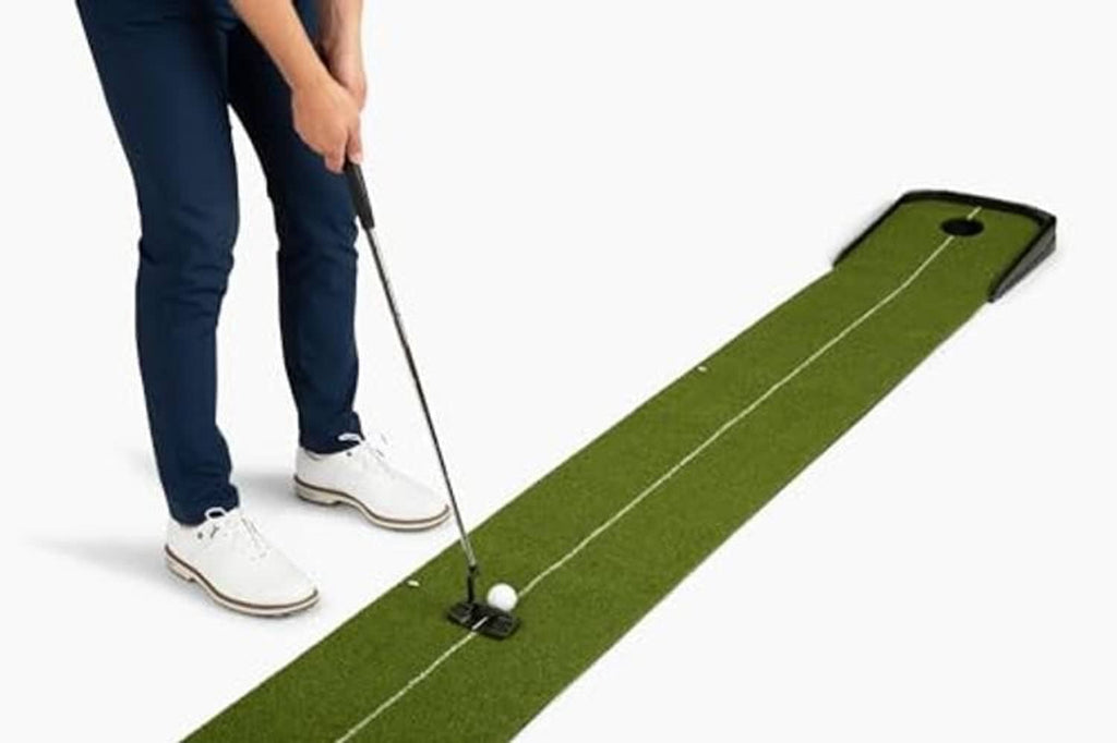 Indoor putting mat with ball return, green surface and white alignment lines