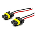 Pair of black headlight wiring connectors with red and black wires, yellow seal ring