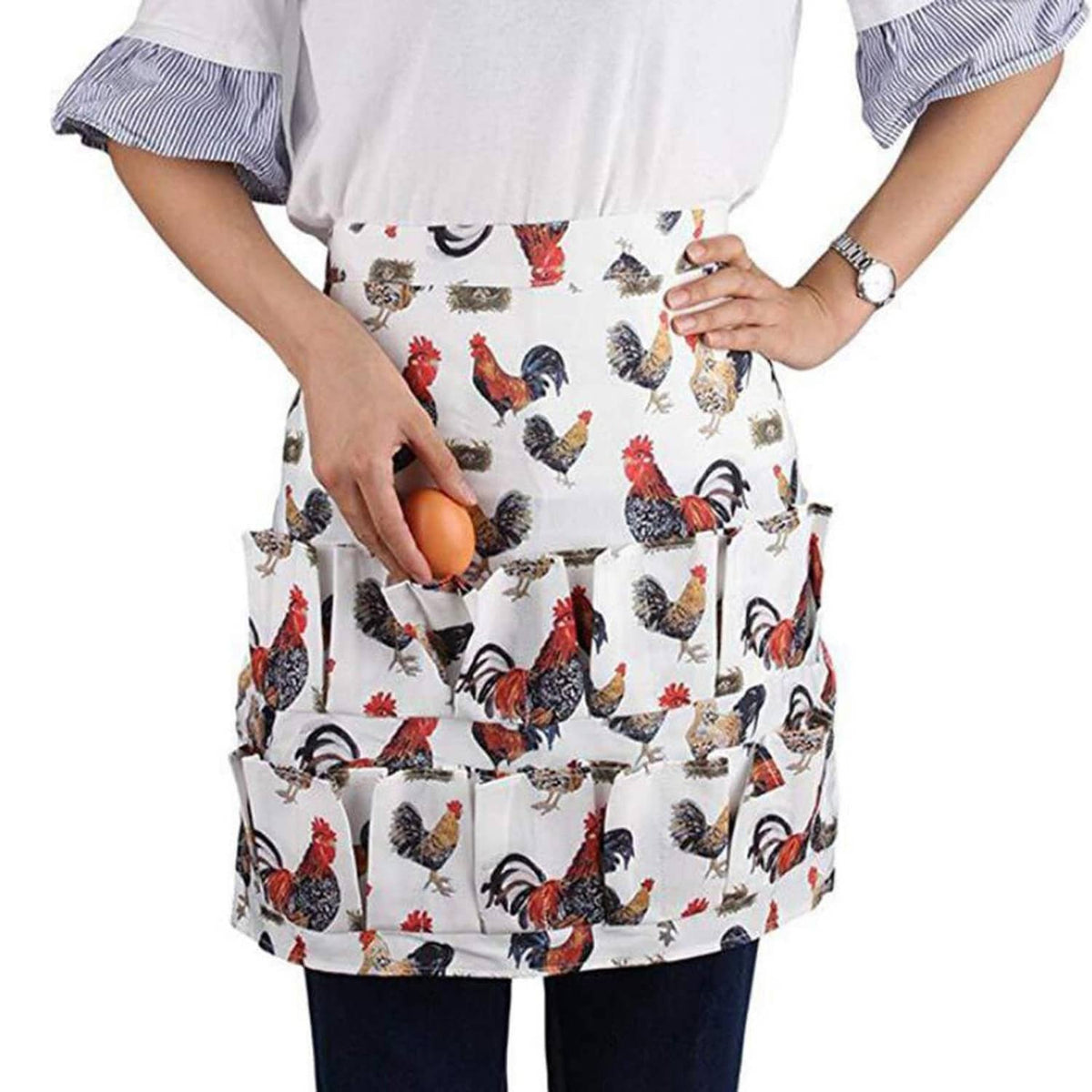 White chicken-printed egg apron with ruffled top and front skirt pockets holding one egg