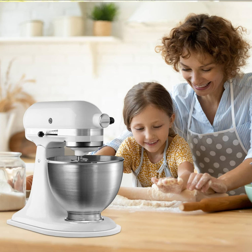 White oval mixer tilt-head slider accessory beside a mixing bowl
