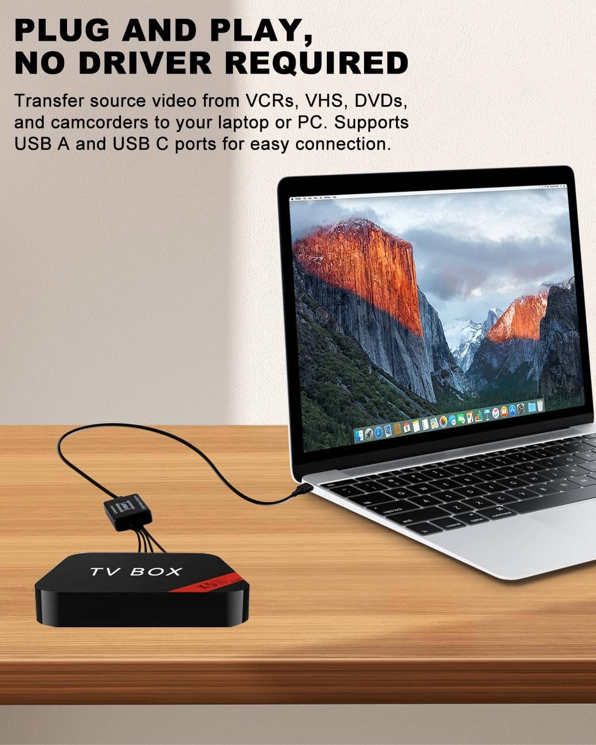 Black TV box converter connected to a laptop with RCA audio/video cables