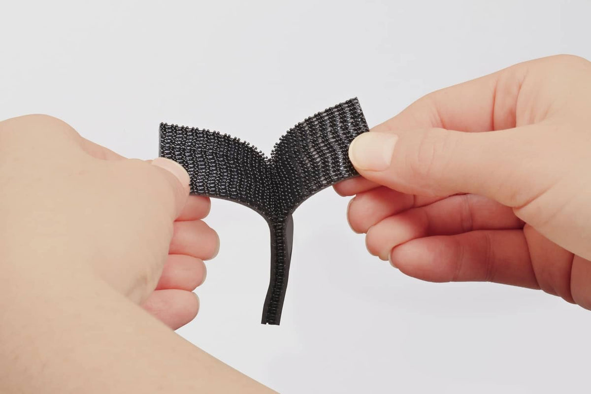 Two black interlocking fastener strips snapped together at an angle