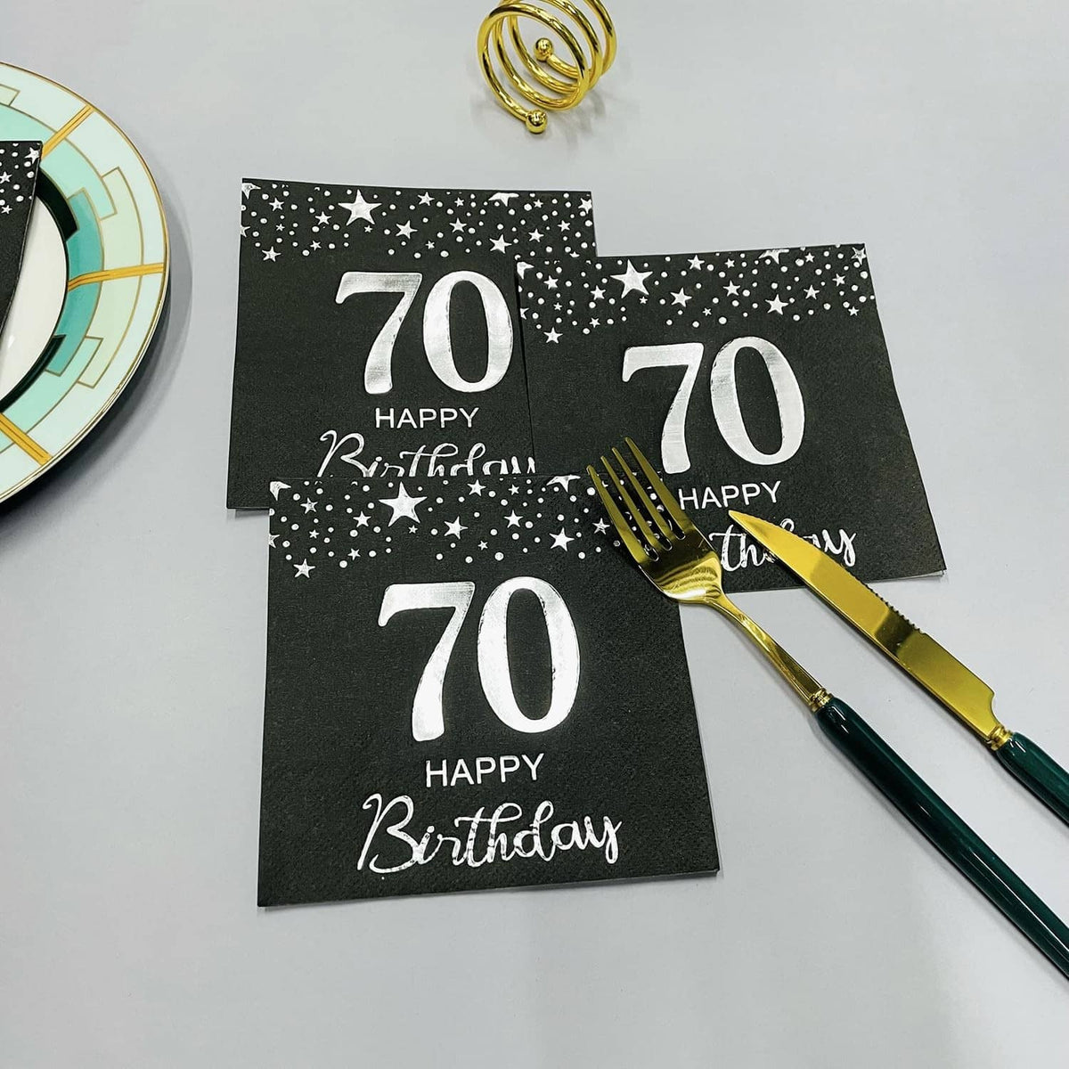 Set of black 70th birthday napkins with stars and silver “70 Happy Birthday”