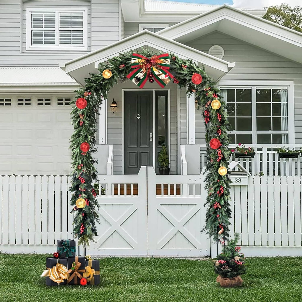 White garden arch trellis decorated with floral garland and red bow on front