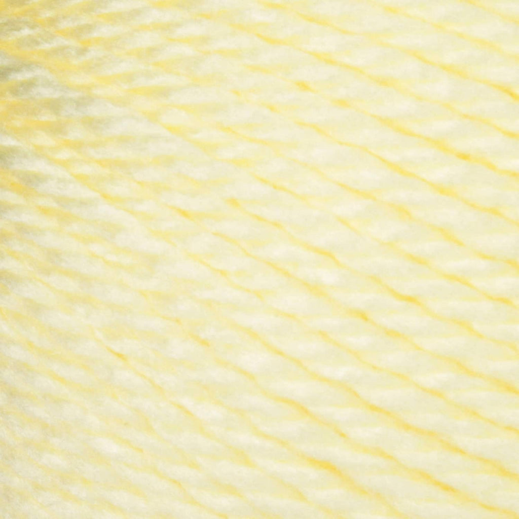 Light yellow acrylic yarn strand close-up texture for knitting and crocheting