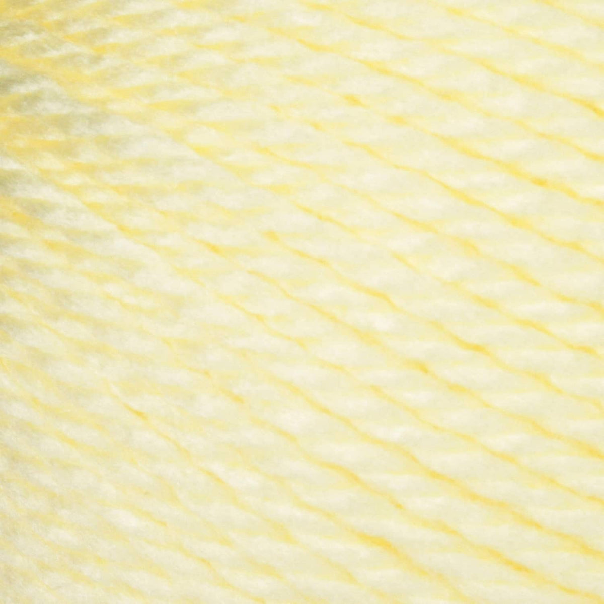 Light yellow acrylic yarn strand close-up texture for knitting and crocheting