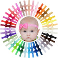 Wide array of baby headbands with multicolor bows on a model