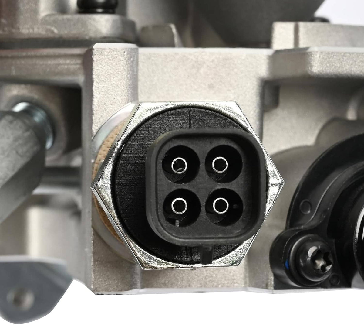 Throttle body electrical connector port with four terminals, silver metal housing.