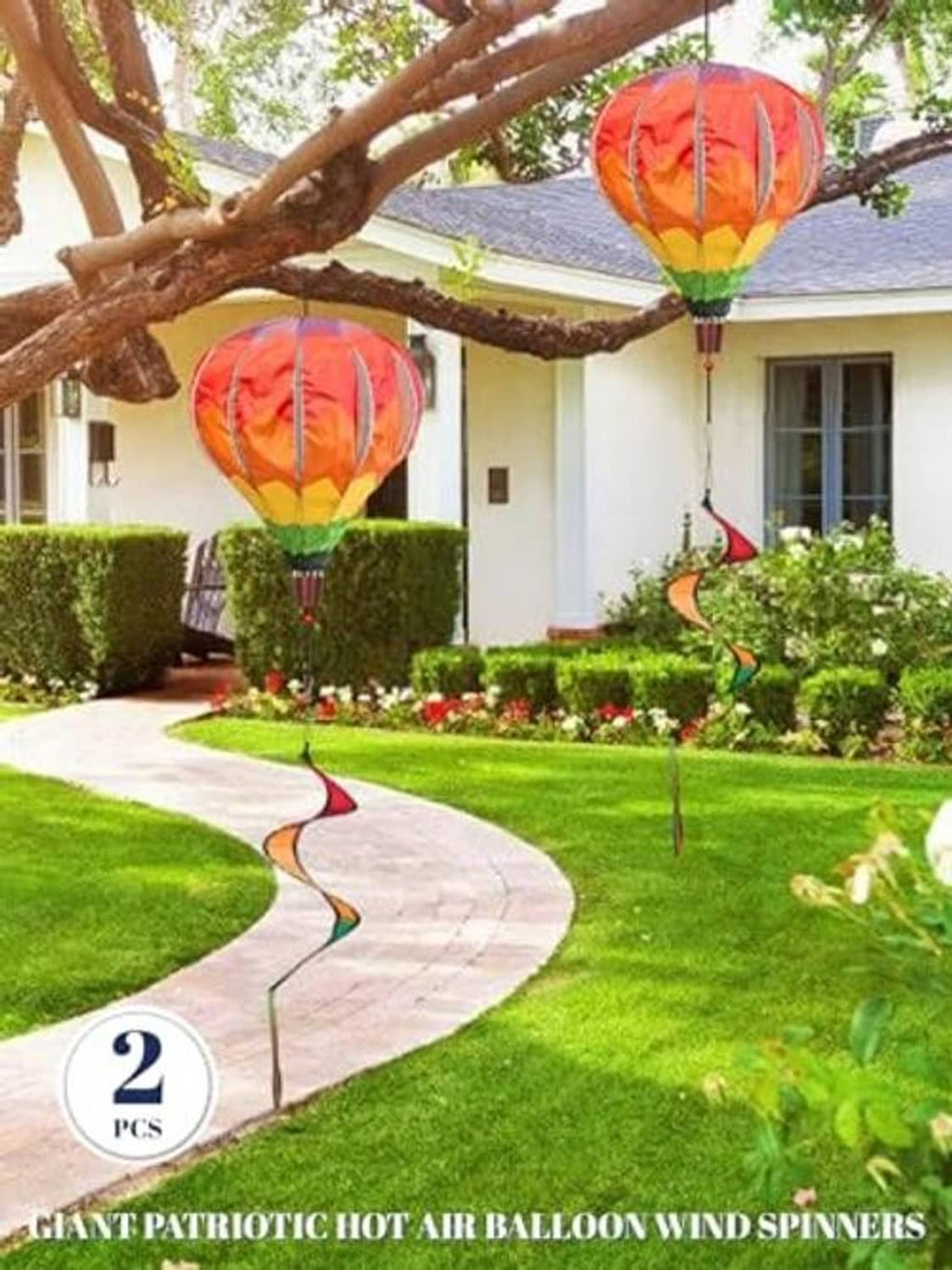 Pair of rainbow hot air balloon wind spinners with swirled ribbon tails for outdoor decor