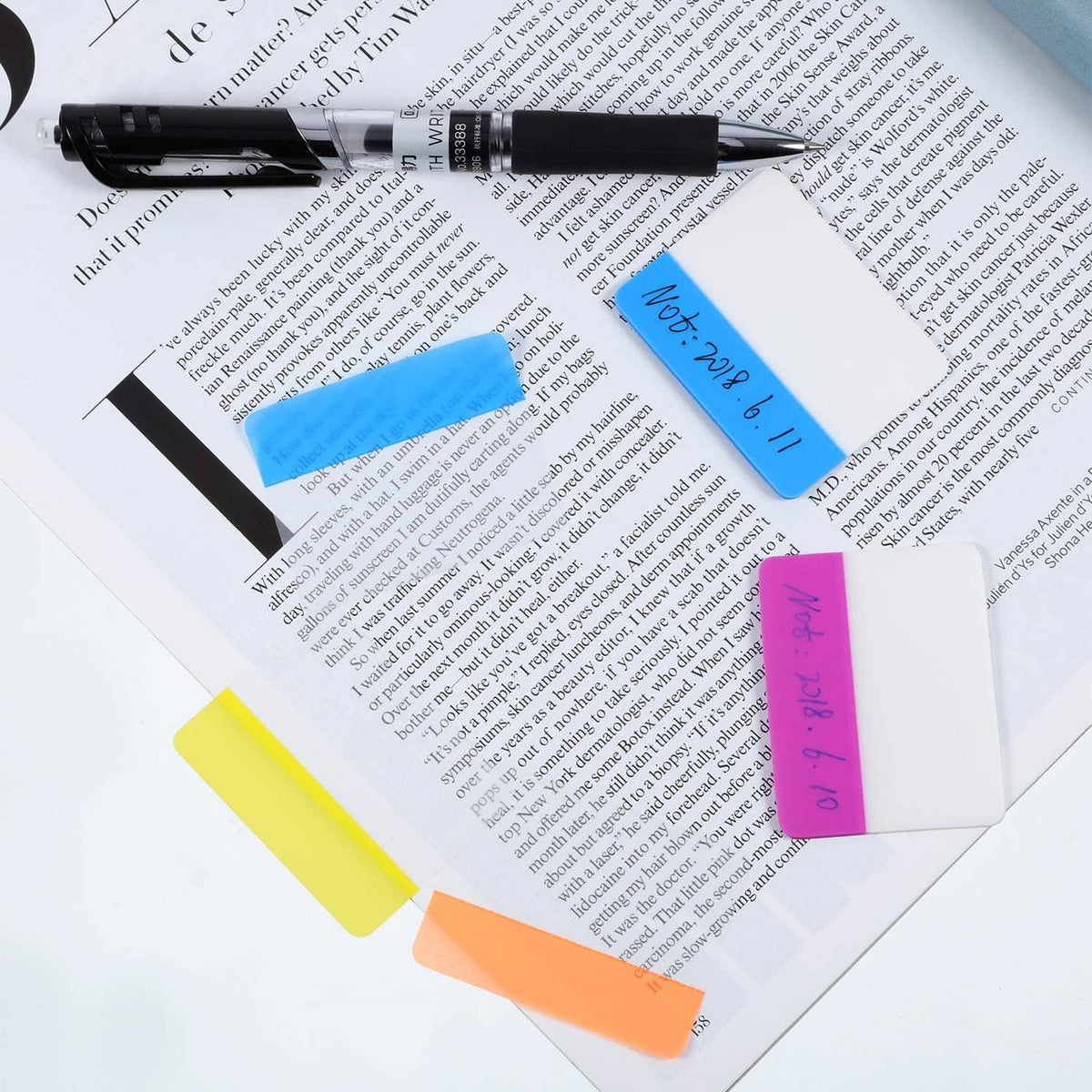 Colored sticky index tabs with handwritten notes on a stack of papers.