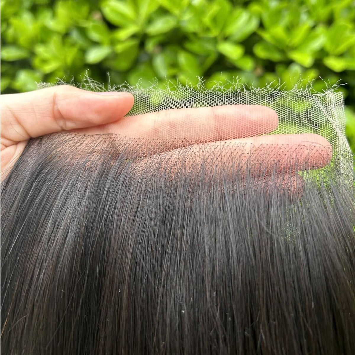 HD lace closure with sheer mesh and straight black hair strands attached