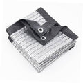 Silver shade tarp folded with black binding and two metal grommets