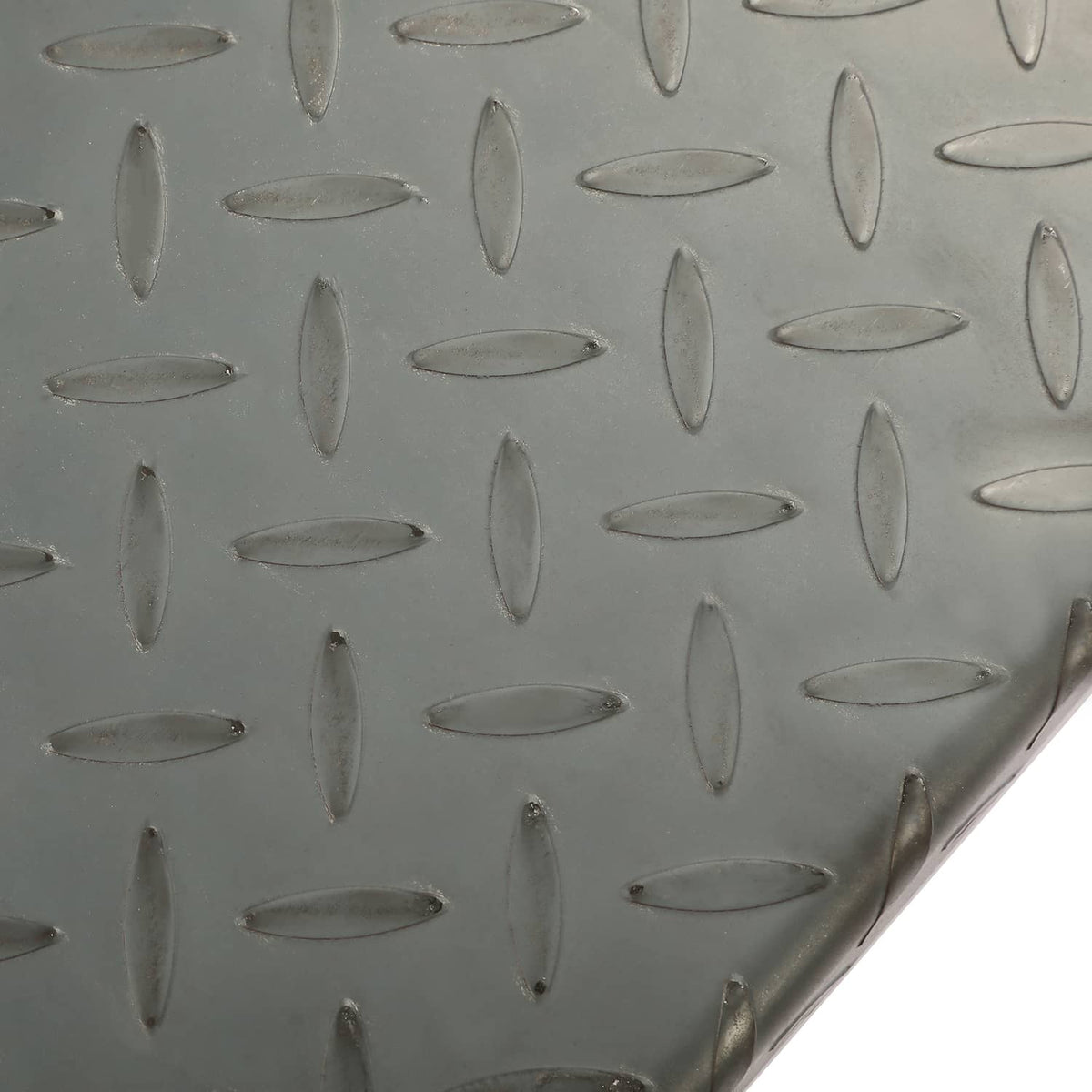 Close-up of steel diamond tread texture on a trailer fender surface
