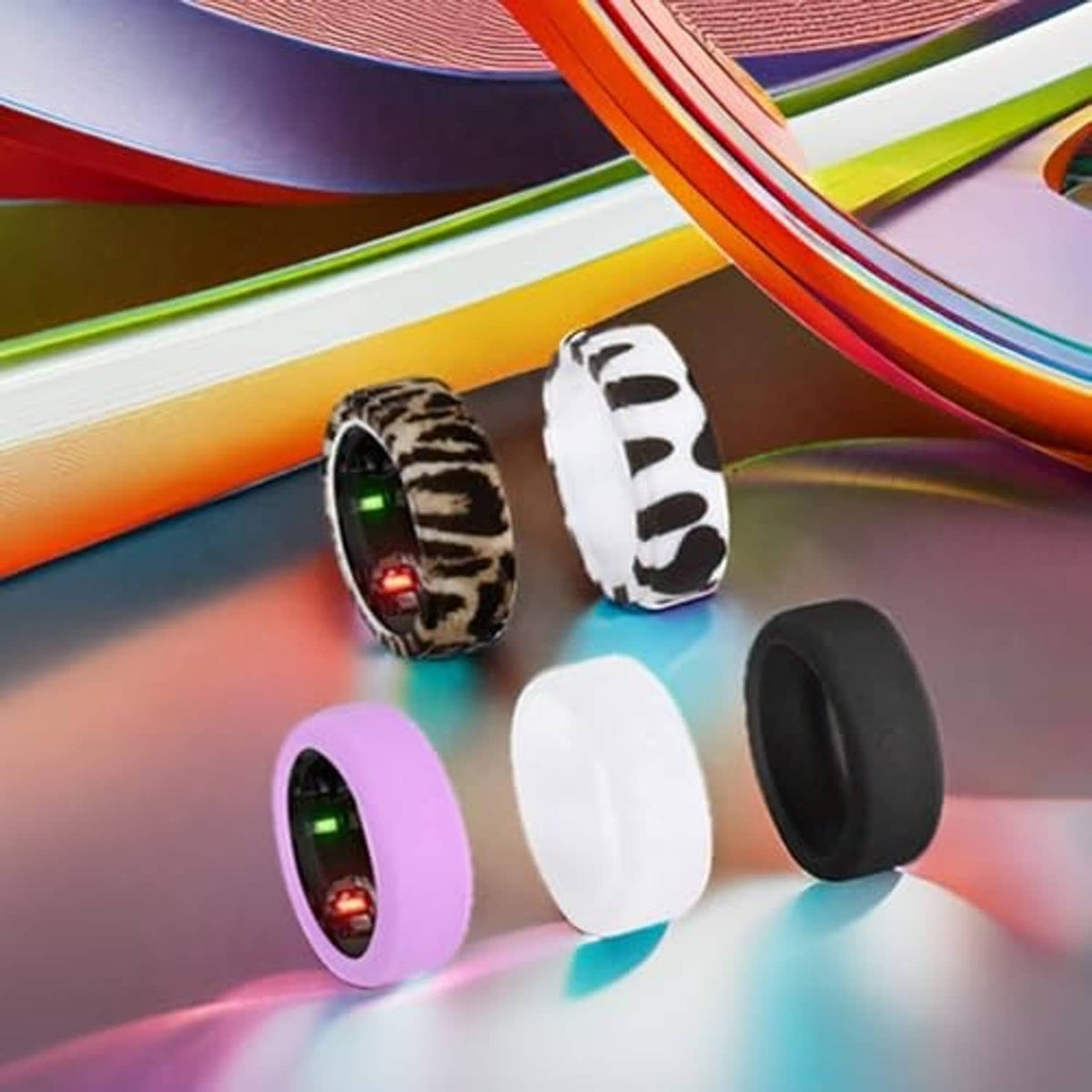 5 ring covers laid out: leopard, zebra, purple, white, and black