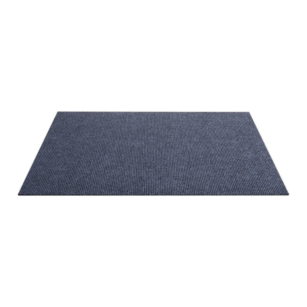 Gray square carpet tile shown from the side to reveal low profile