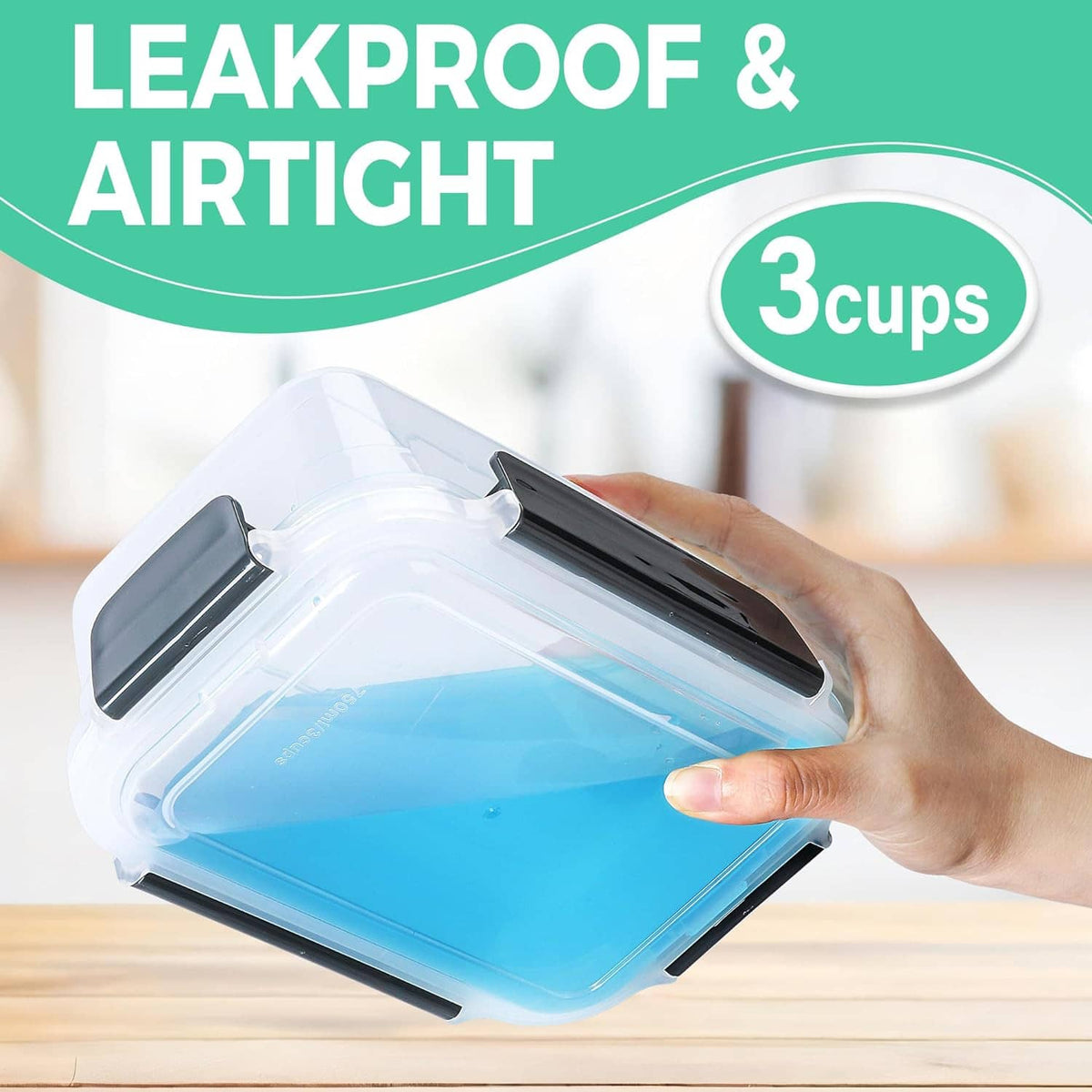 Clear plastic 3-cup food container with black latch lid, held by hand
