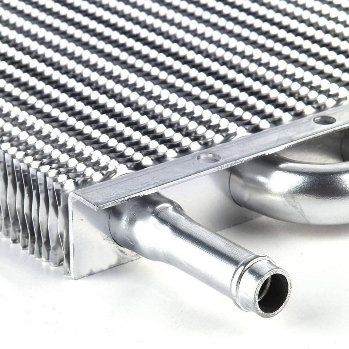 Close-up of aluminum tube-and-fin oil cooler end tank and inlet/outlet pipe