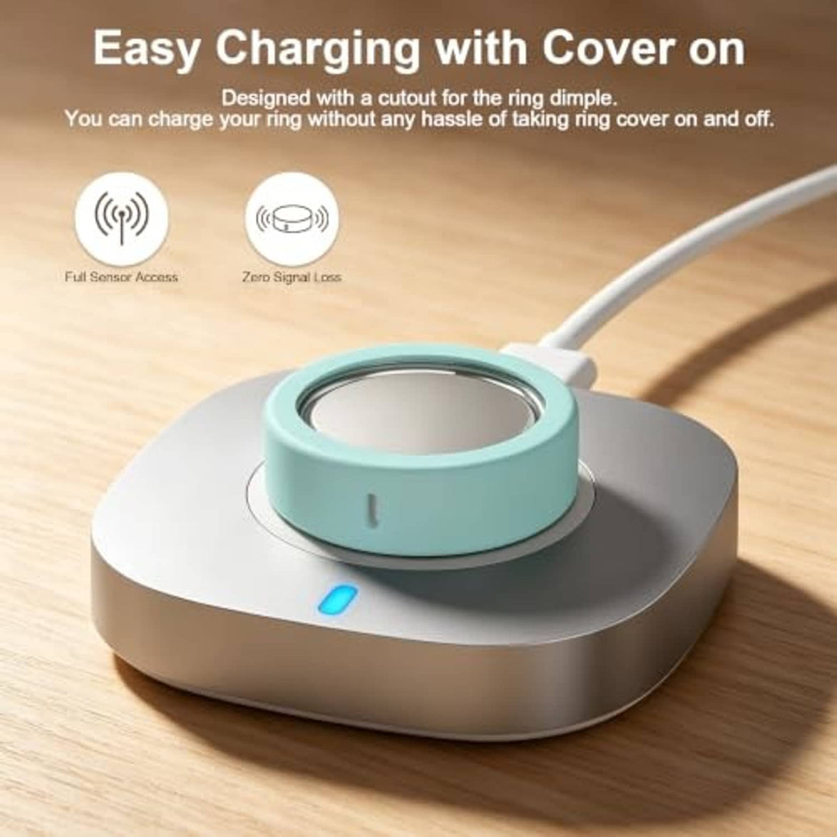 Teal silicone ring cover with open sensor window on a gray charging dock