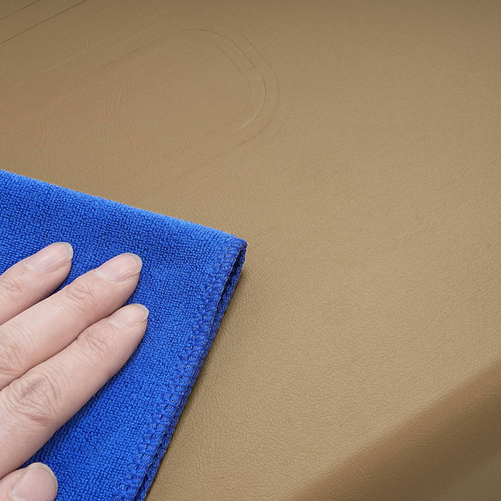 Tan cushion upholstery texture with hand pressing on the edge