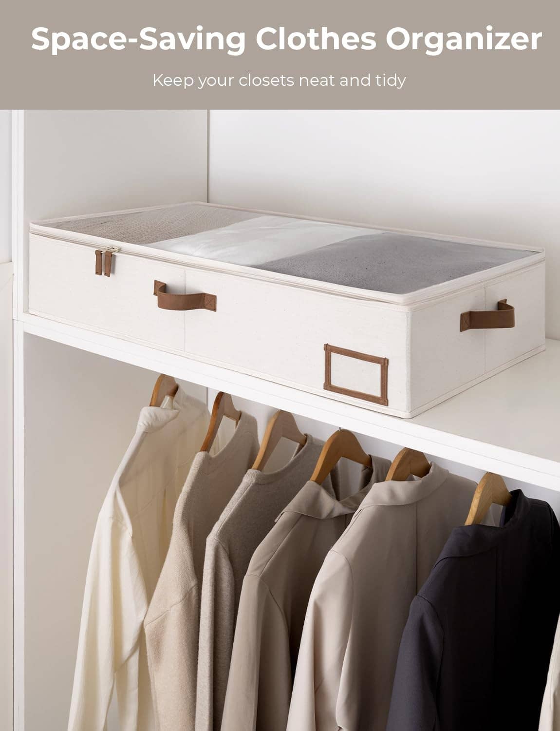 Under-bed clothes organizer bin with brown handles and label window, storing folded clothes