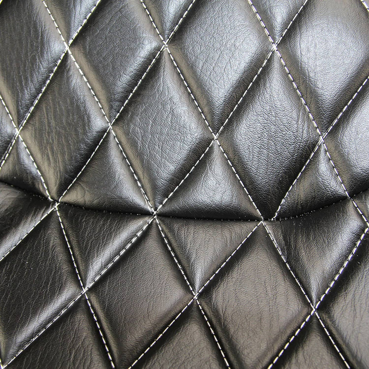 Close-up of black diamond-quilt seat leather with stitched seam lines