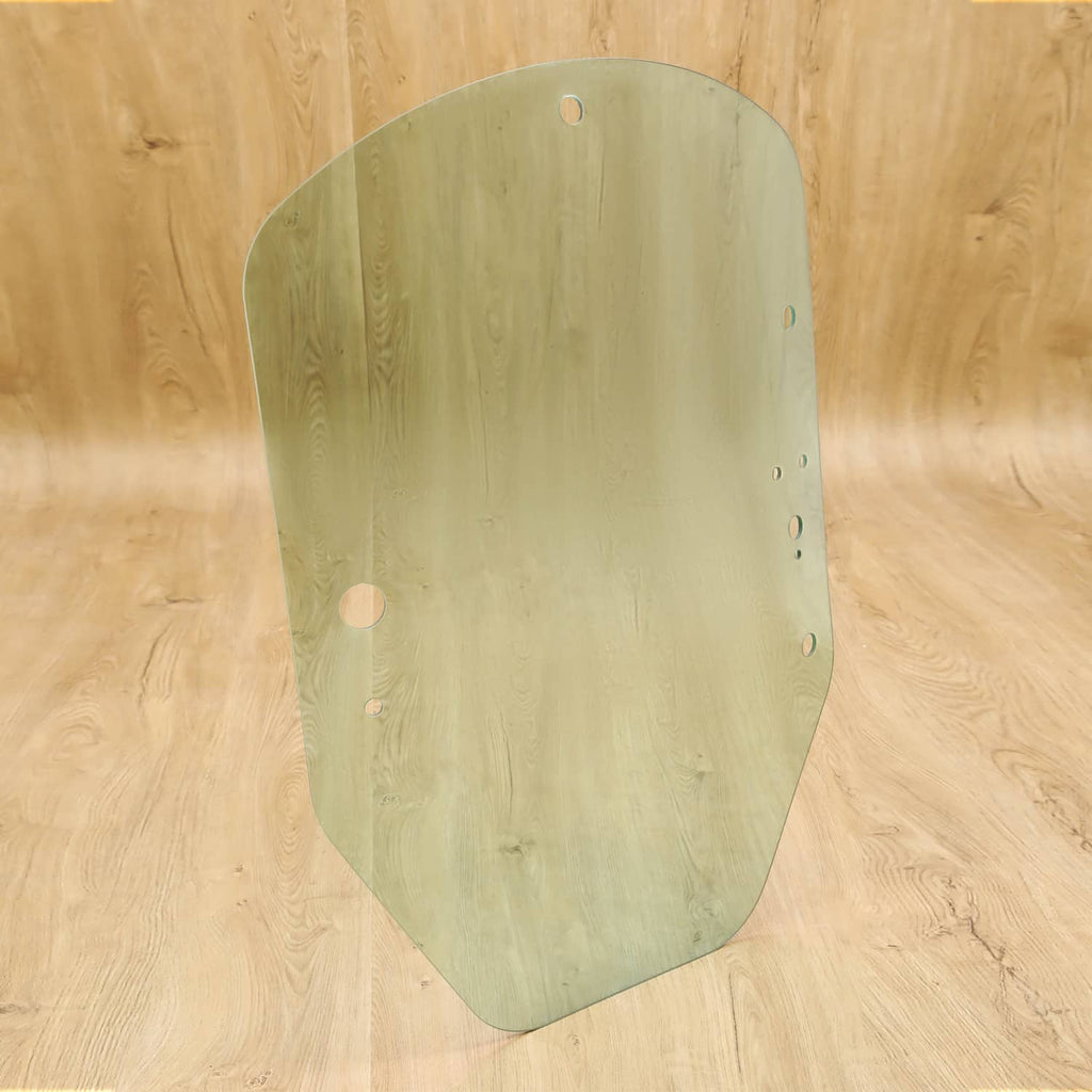 Green-tinted cab door glass with rounded top and side mounting holes