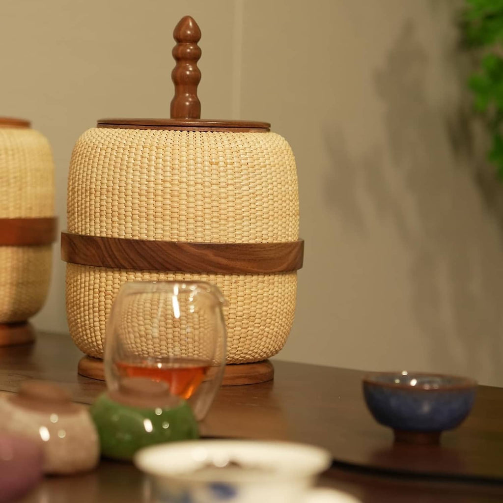 Woven rattan storage basket with wooden lid and finial, yellow beige