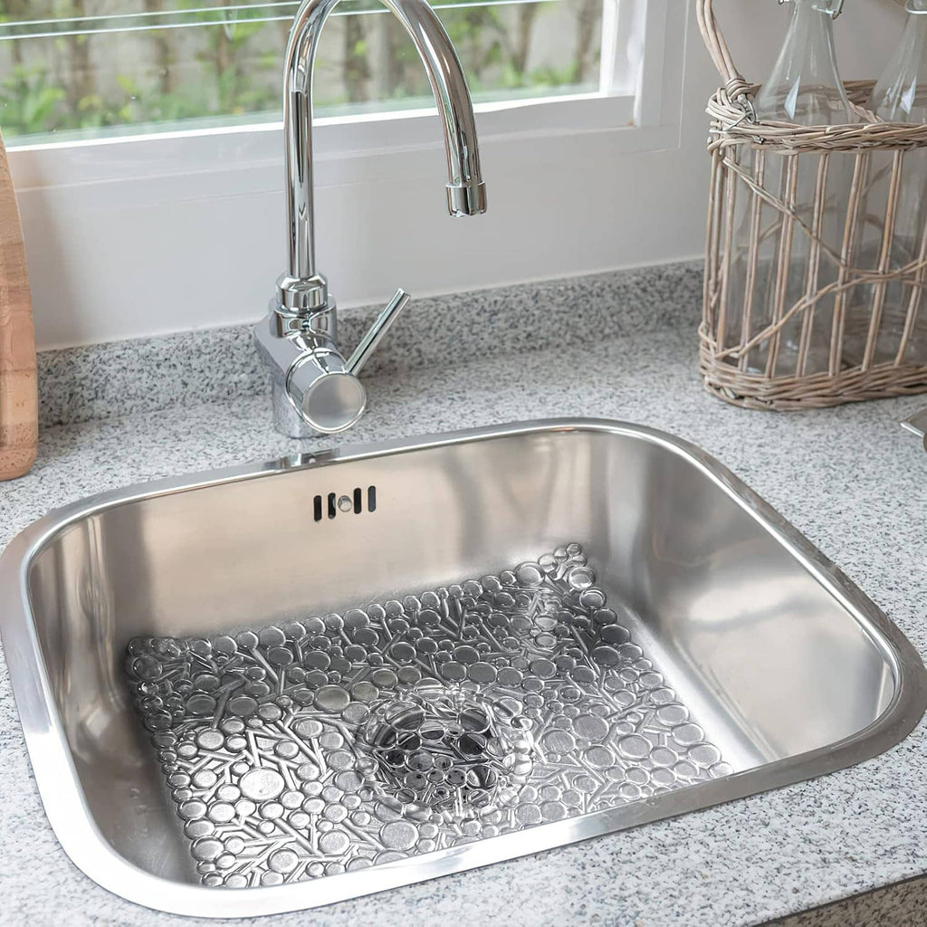 White textured PVC sink mat with raised bubbles inside stainless steel sink