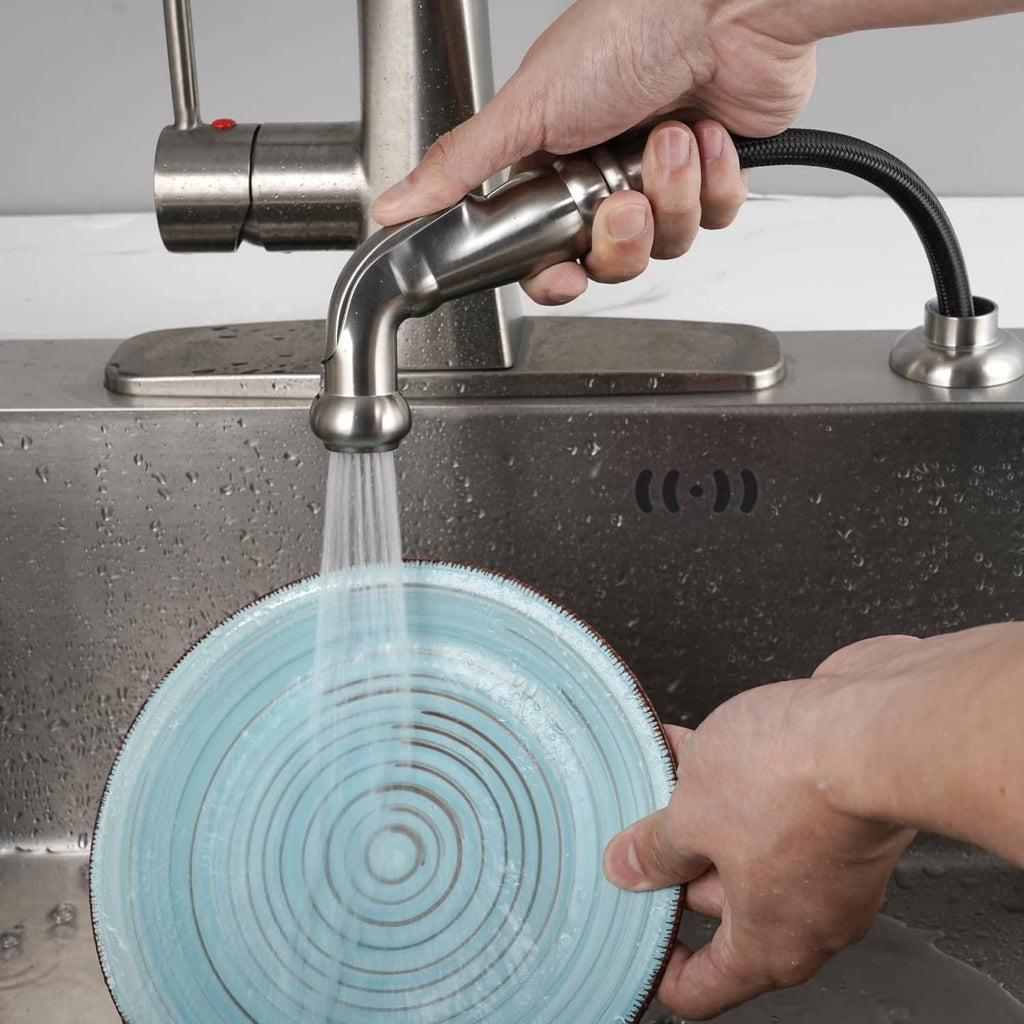 Brushed nickel sink sprayer attachment delivering a water stream