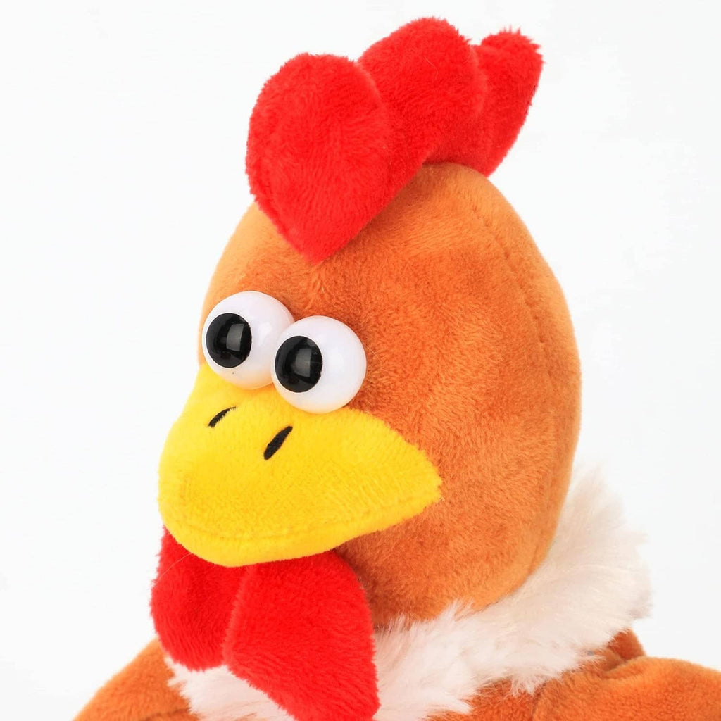 Close-up of orange talking chicken plush face, red comb, round eyes, yellow beak