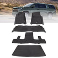 Black 2nd-row bucket floor mat liners set with molded channels and raised edges