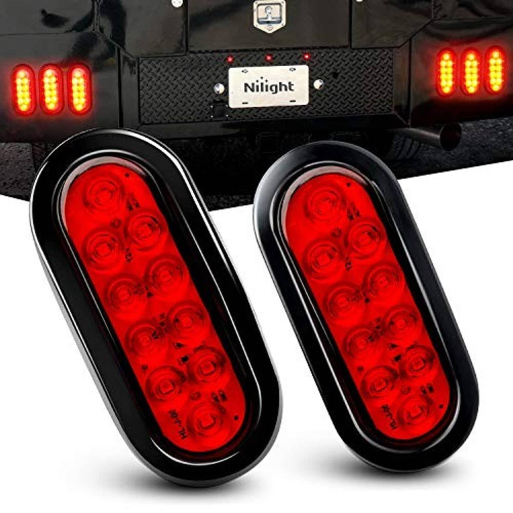 Two oval red LED tail lights on trailer rear, illuminated