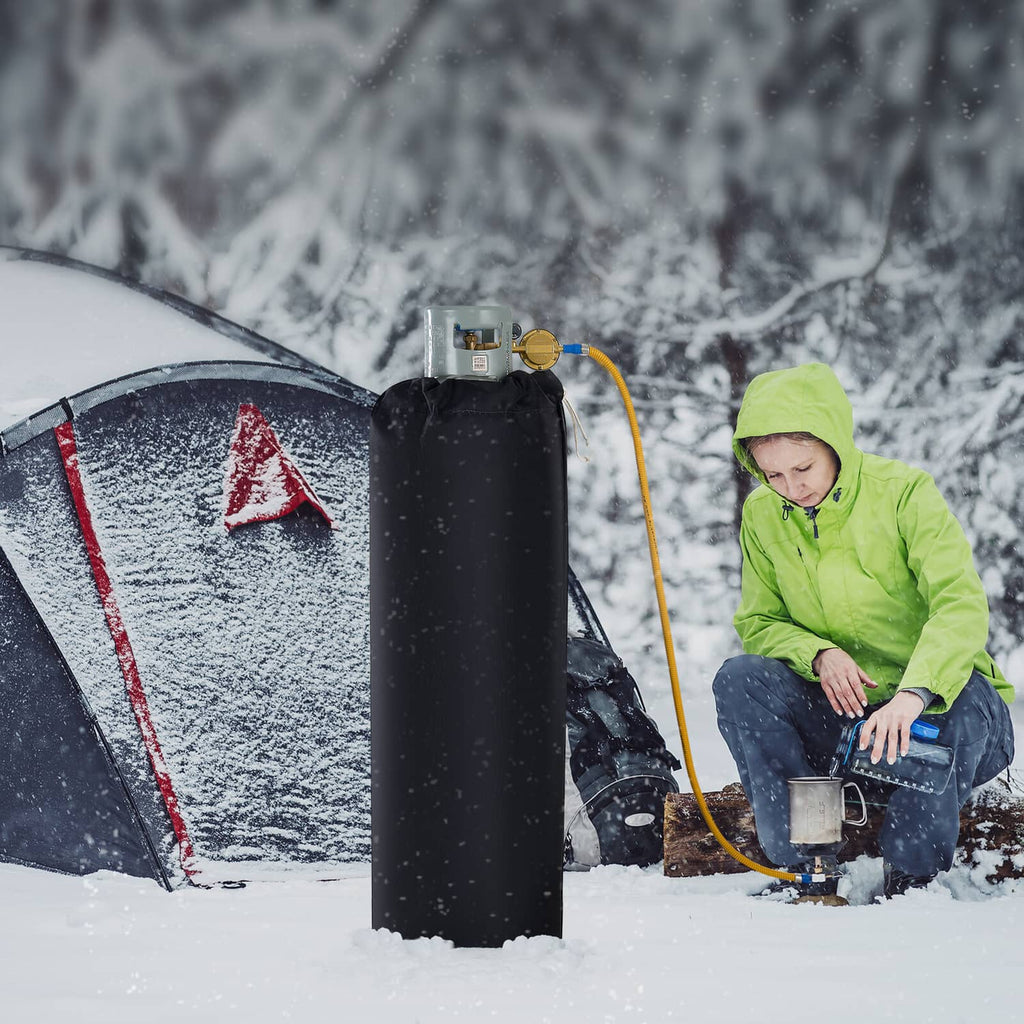 Black insulated gas cylinder warmer wrapped on a propane cylinder with connected hose.