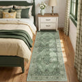 Rectangular green washable area rug with ornate distressed medallion pattern and border, 3x8 ft