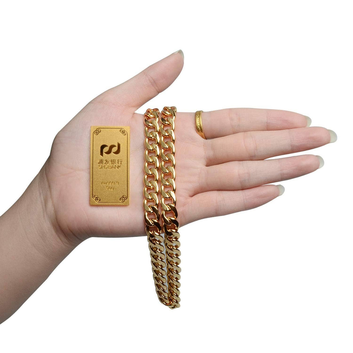 Gold chain necklace held in a hand, showing thick curb links