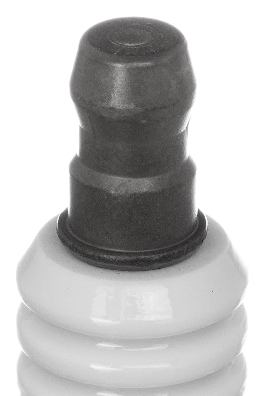 NGK spark plug insulator boot and metal base, close-up