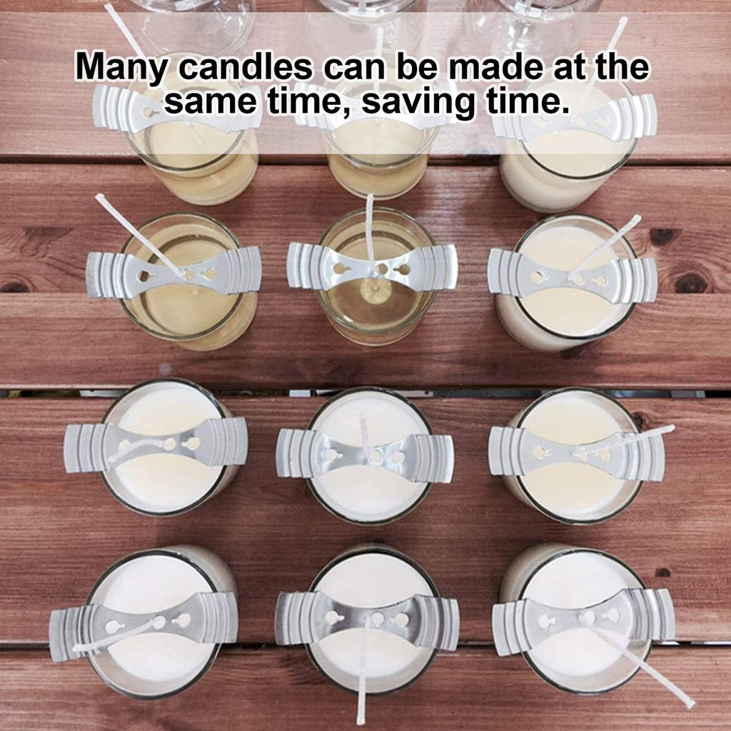 Silver wick centering clips on multiple small candles arranged on a wooden surface